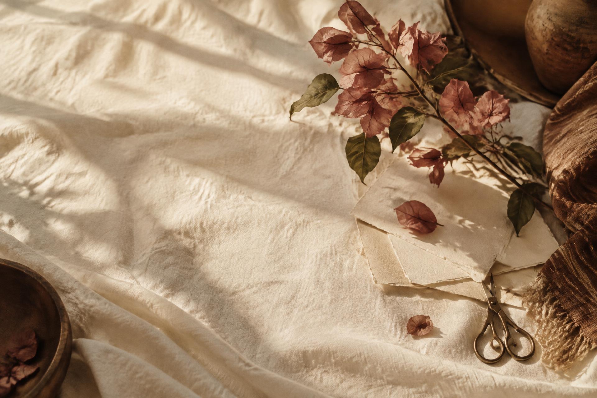 Ivory linen, handmade paper, and bougainvillea in warm afternoon light